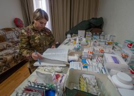 A battalion paramedic of the 13th brigade of the NSU "Charter" collects medicines for the evacuation of the wounded