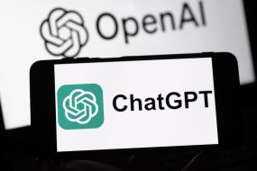 ChatGPT logo on a smartphone screen against the background of the logo of the developer company OpenAI