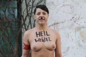 Topless FEMEN activist near the German Embassy in Kyiv