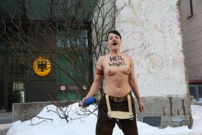 Topless FEMEN activist near the German Embassy in Kyiv
