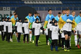 Football players enter the field before the start of the match