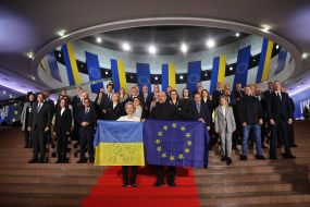 Денис Шмигаль та Урсула фон дер Ляєн тримають прапори України та ЄС