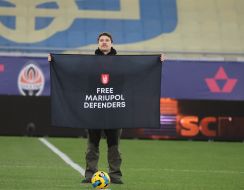 A man holds a poster "Free Mariupol defenders"