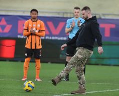 A serviceman of the Armed Forces of Ukraine performs the first symbolic kick at the ball