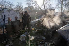 Rescuers extinguish a fire after a rocket attack on Kharkiv