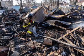 Rescuers extinguish a fire after a rocket attack on Kharkiv