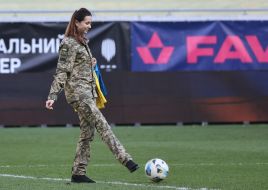 Ukrainian military woman with the flag of Ukraine