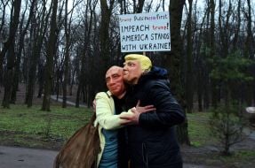 Activists wearing masks of Donald Trump and Vladimir Putin