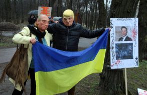 Activists wearing masks of Donald Trump and Vladimir Putin