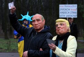 Activists wearing masks of Donald Trump and Vladimir Putin