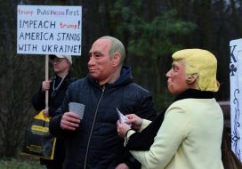 Activists wearing masks of Donald Trump and Vladimir Putin
