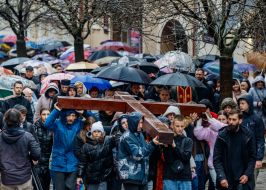 Children carry the Cross down the street in Uzhhorod