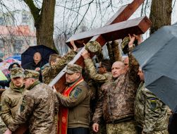 Military carry the Cross down the street in Uzhhorod