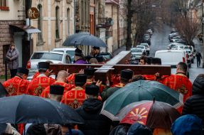 Clergymen carry the Cross down the street in Uzhhorod