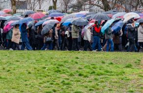 Believers walk under umbrellas through the streets of Uzhhorod