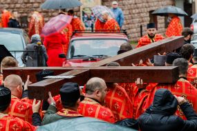 Clergymen carry the Cross down the street in Uzhhorod