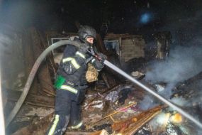 A rescuer puts out a fire at the arrival site of one of the Russian Geran-2 strike drones.