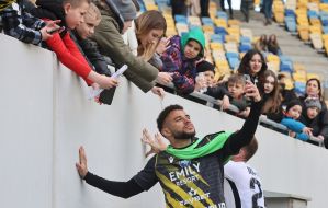A player from FC Rukh takes a selfie with fans