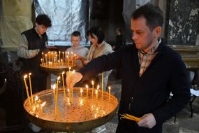 Believers light candles in church