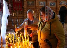 Believers light candles