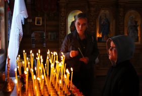 Believers light candles