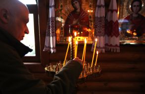 Believers light candles