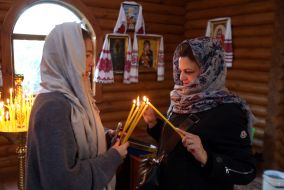Believers light candles