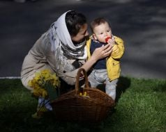 Woman with child near Easter basket