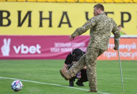 A serviceman makes the first symbolic kick at the ball