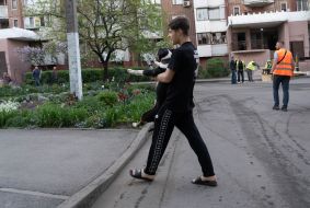 A man carries a dog in his arms after a massive Russian attack with mortars and missiles on Kharkiv