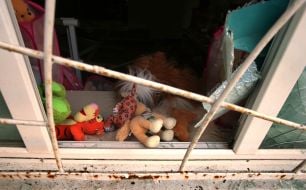 Children's toys on a window of the "Bdzhilka" children's club shattered by a blast wave after a massive Russian attack on Kyiv
