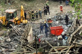 A moment of silence, near the rubble of a building, to hear cries for help, after the massive Russian attack on Kyiv