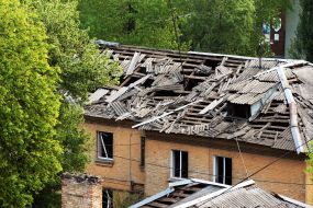 A collapsed roof and broken windows in a house next to the one hit by a rocket in Kyiv