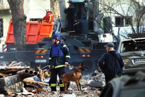 Dog handlers with search dogs at the site of a destroyed house after a massive Russian attack on Kyiv