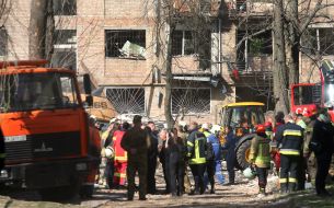 A moment of silence, near the rubble of a building, to hear cries for help, after the massive Russian attack on Kyiv