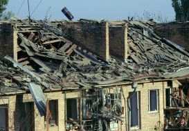 A collapsed roof and broken windows in a house next to the one hit by a rocket in Kyiv