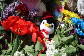 People brought flowers and toys to a house destroyed by a Russian missile