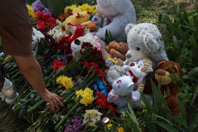 People brought flowers and toys to a house destroyed by a Russian missile