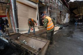 Municipal workers clean up after enemy shelling by a Geran-2 UAV at the Barabashovo market in Kharkiv