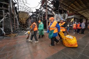 Municipal workers clean up after enemy shelling by a Geran-2 UAV at the Barabashovo market in Kharkiv