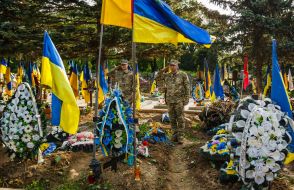 A serviceman honors the memory of his fallen comrades