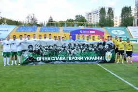 Игроки ФК «Карпаты» (Львов) и ФК «Александрия» (Александрия) держат баннер с надписью: "Вечная слава героям Украины!"