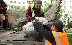 Municipal workers clean up after a massive combined attack on the city in the Obolonskyi district of Kyiv