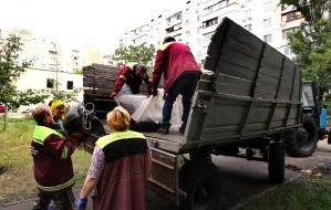 Municipal workers clean up after a massive combined attack on the city in the Obolonskyi district of Kyiv