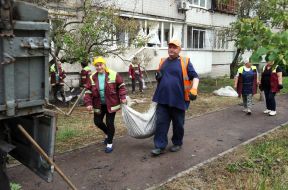 Municipal workers clean up after a massive combined attack on the city in the Obolonskyi district of Kyiv