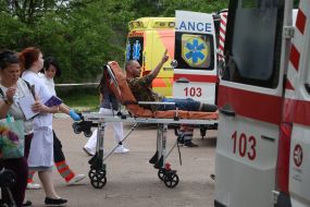 A prisoner of war from the second stage of the 1,000-for-1,000 exchange is brought to the hospital's emergency department on a gurney