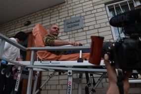 A prisoner of war from the second stage of the 1,000-for-1,000 exchange is brought to the hospital's emergency department on a gurney