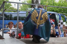 Women show photos of missing persons to a prisoner of war who returned to Ukraine