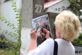 Woman holding photos of missing people
