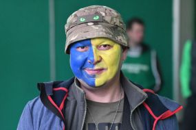 Man with face painted in Ukrainian flag colors